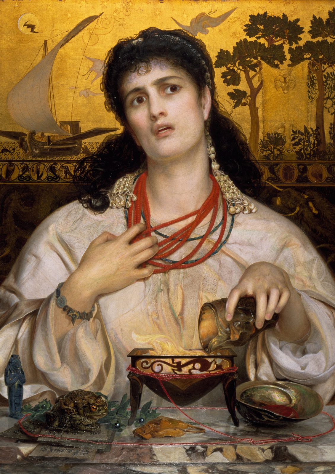 Medea by Frederick Sandys, 1868, as a framed print in a black frame on a cream wall. A dark-haired woman in a white robe and coral necklaces pours a potion into a glowing brazier, with the ship Argo and the Golden Fleece painted on a gold background behind her.
