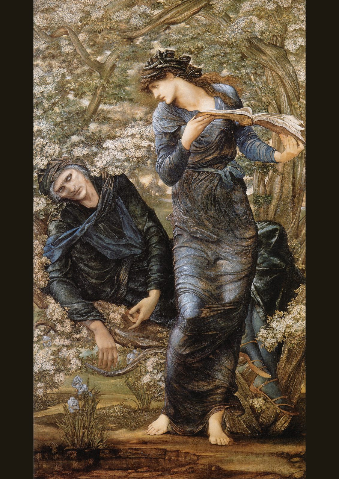 The Beguiling of Merlin by Edward Burne-Jones. Nimue, in a flowing blue gown with snakes in her hair, reads a book of spells while Merlin lies helpless in a flowering hawthorn tree.