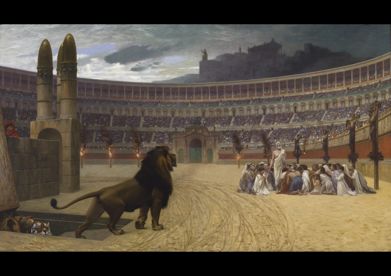 The Christian Martyrs' Last Prayer by Jean-Léon Gérôme, 1883, in a gold frame. A lion climbs from a trapdoor into a vast sunlit Roman arena packed with spectators, while an old man stands among kneeling Christians and burning crosses line the far wall.
