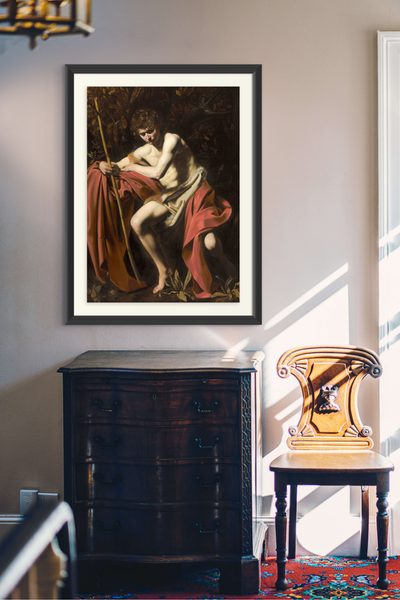 Saint John the Baptist in the Wilderness by Caravaggio as a framed print in a living room